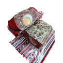 Sliced Drob de miel from DELUMANI, a traditional Romanian lamb meatloaf, served on a white plate with herbs.